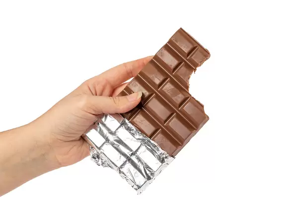 Bitten chocolate bar in a woman's hand