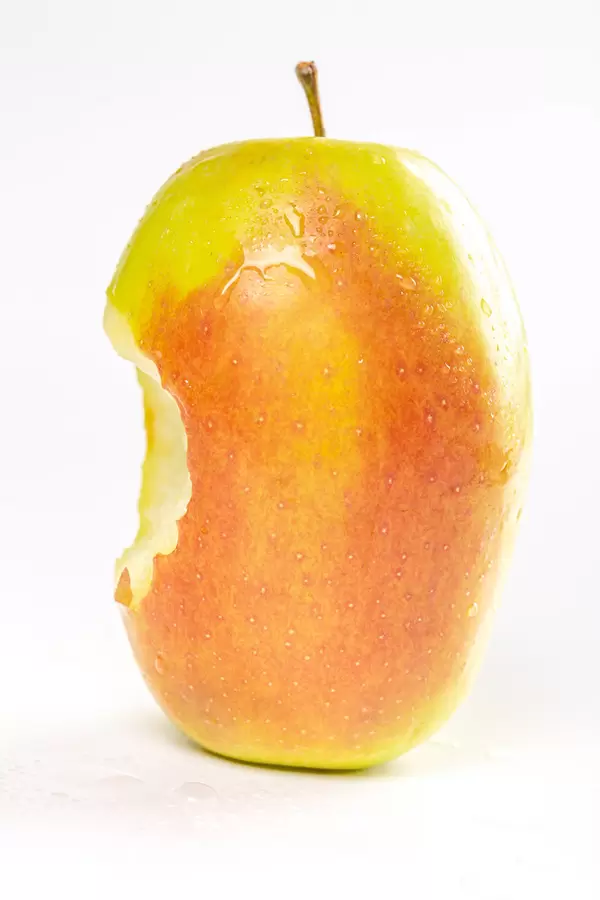 Bitten fresh apple on a white background