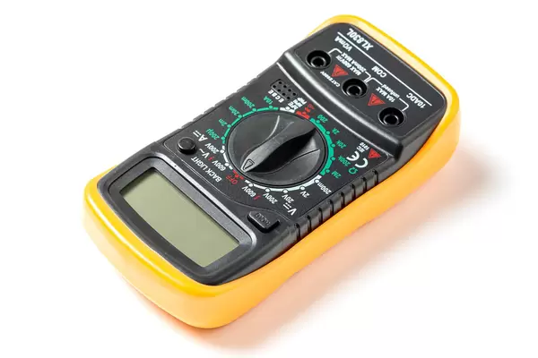 Black and yellow electrical multitester on white background