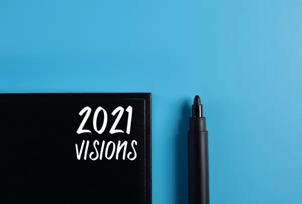 Black book with 2021 text and black marker on blue background