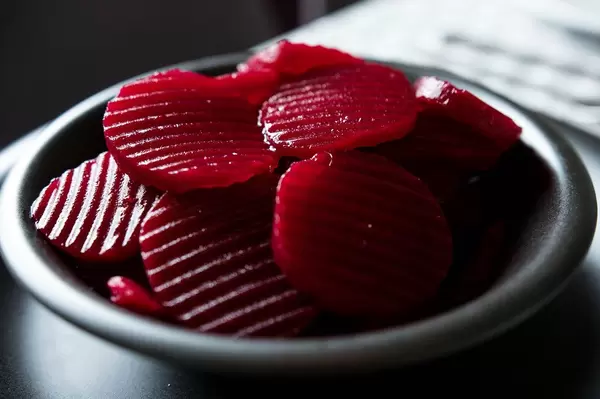 Black bowl full of beet slices