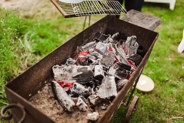 Black Coal With Flame Closeup Photo On Ash Background