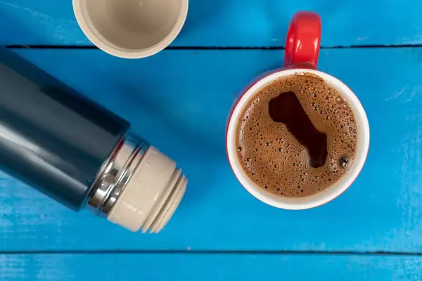 Black Coffee in the cup with Thermo Bottle on the table (Flip 2020)