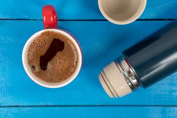 Black-Coffee-in-the-cup-with-Thermo-Bottle-on-the-table.jpg