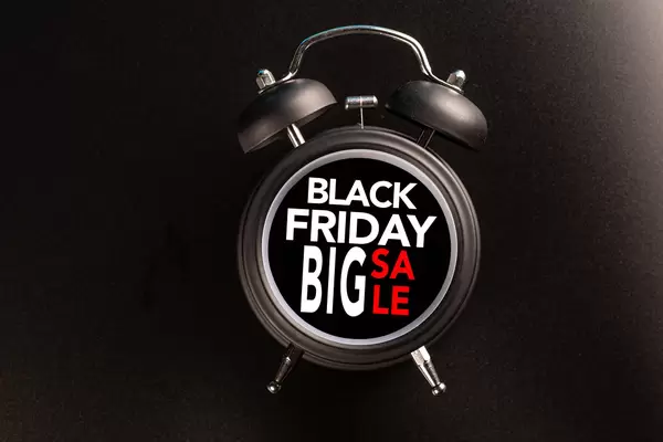 Black Friday text on black alarm clock, sale concept