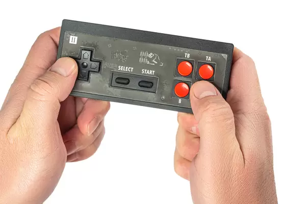 Black joystick in hands on white