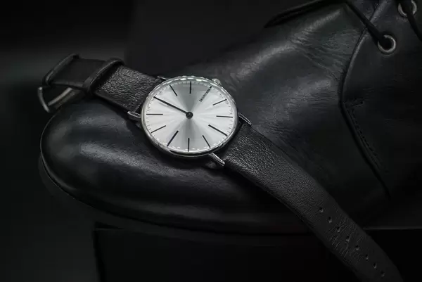 Black leather shoes and wrist watch. Formal dress code