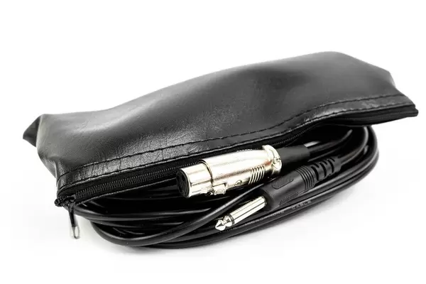 Black microphone cable with XLR connectors and case above white background