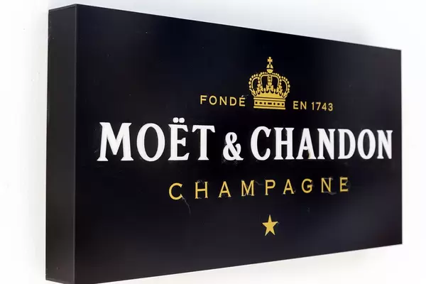 Black Moët & Chandon Champagne sign on white wall in Mykonos, Greece