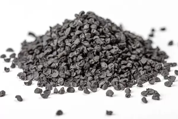 Black onion seeds on a white background, close-up (Flip 2020)