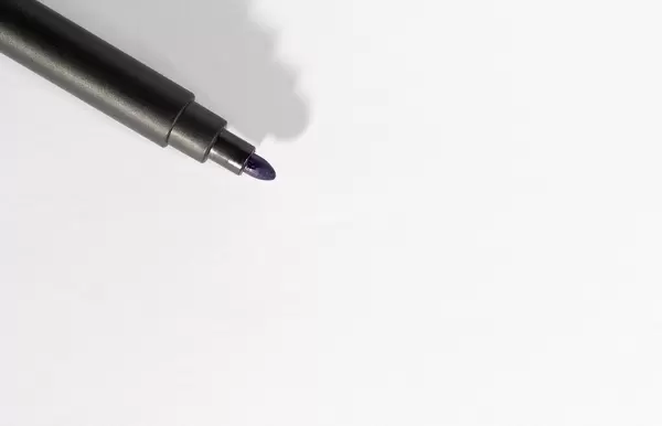 Black open marker on white paper