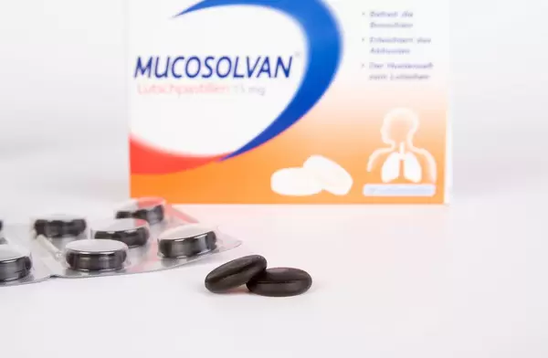 Black pills on white background