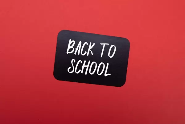 Black sticker with Back to School text on red background
