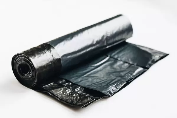 Black trash bags on white background