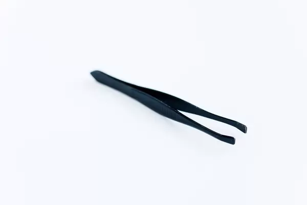 Black tweezers on white background.