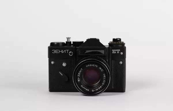 Black vintage film camera on white background