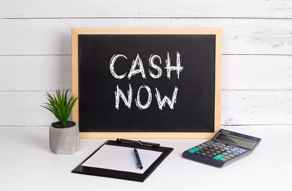 Blackboard with Cash Now text