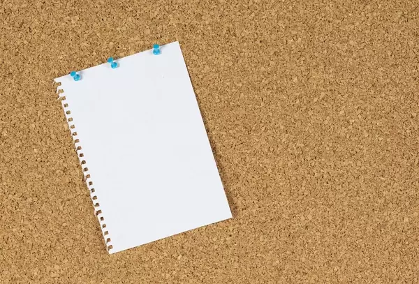 Blatt Papier angeheftet an eine Tafel aus Korken