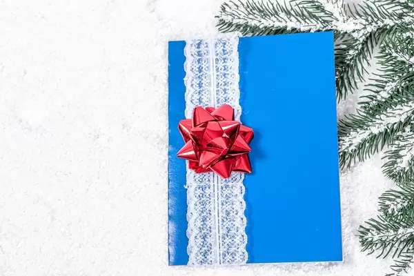 Blaue Grußkarte mit weißem Spitzenband und Roter Schleife