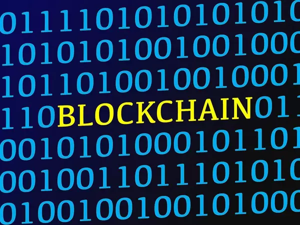 Blockchain text between blue binary data on screen