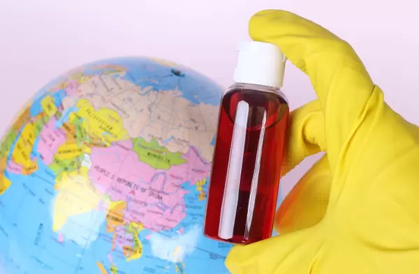 Blood sample in test tube with globe in the background