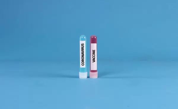 Blue and red test tubes with Coronavirus Vaccine text