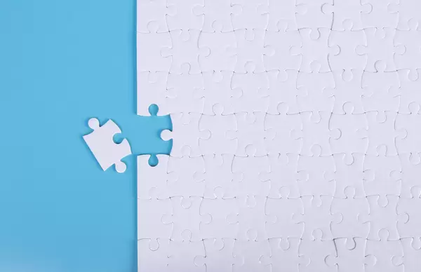 Blue background made from white puzzle pieces