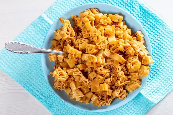 Blue bowl full of pasta with sauce and fried minced meat. Top view (Flip 2019)