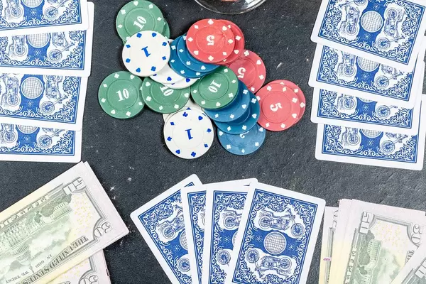 Blue cards with chips and dollars on the table. The concept of gambling