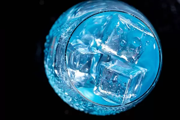 Blue cocktail with ice cubes. Top view