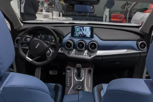 Blue interior of Nobo VV7 Concept Cabin, with black honeycomb intake grille and full LCD instruments