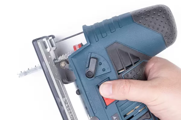 Blue Jigsaw in the hand above white background