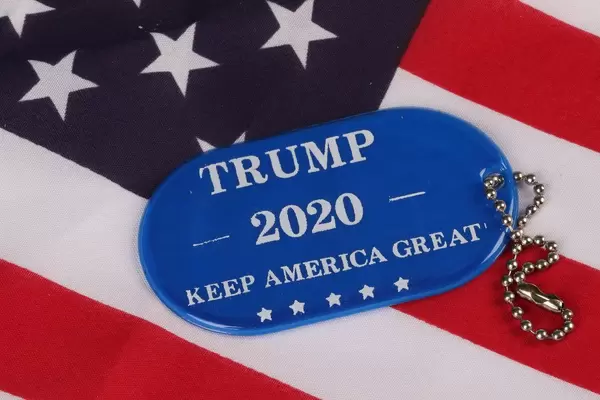 Blue military tag with Trump 2020 text on American flag