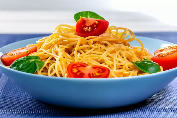 Blue plate filled with spaghetti