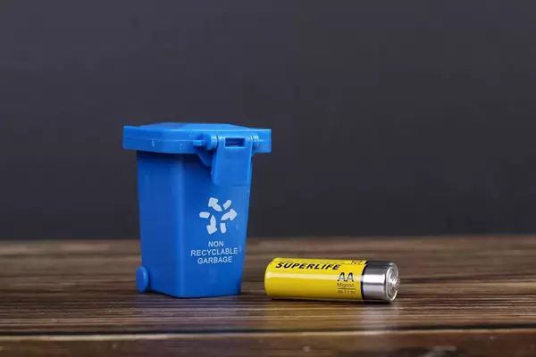 Blue recycle bin with battery