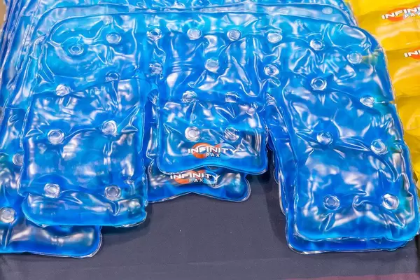 Blue version of the reusable pain relief heating pads for neck and shoulders, Infinity Pax, on display at the Chicago Marathon 2019 Expo