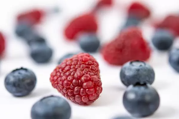 Blueberries and Raspberries on the white background table (Flip 2019)