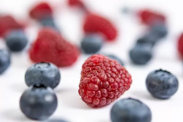 Blueberries and Raspberries on the white background table