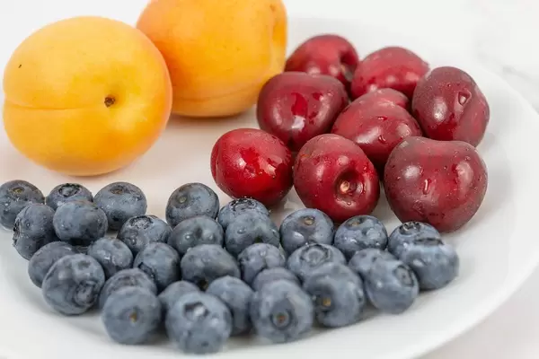 Blueberries Apricots and Cherries arranged on the plate (Flip 2019)