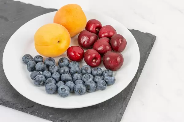 Blueberries Apricots and Cherries served on the plate (Flip 2019)