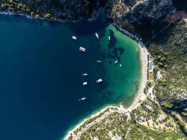Boats in the emerald green waters of the bay of Limnonari, Skopelos. Drone photo, top view