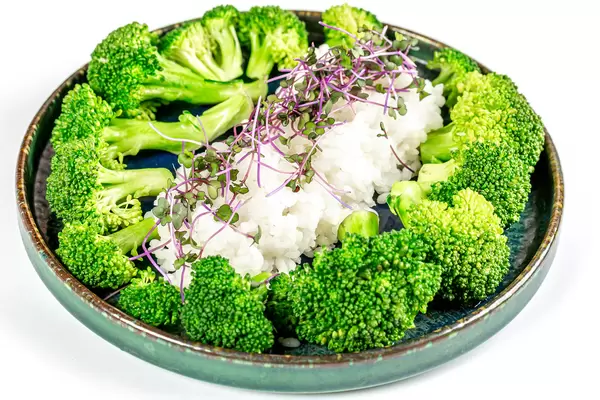 Boiled rice with broccoli and micro-green cabbage, close-up