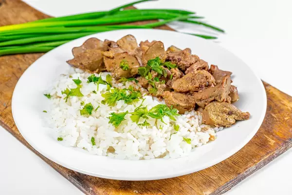 Boiled rice with chicken giblets and greens