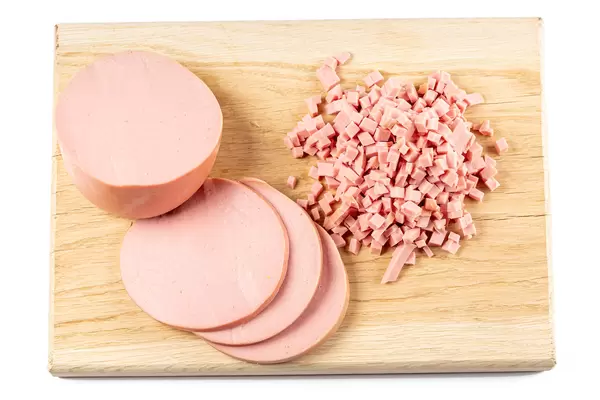 Boiled sausage sliced on a cutting board
