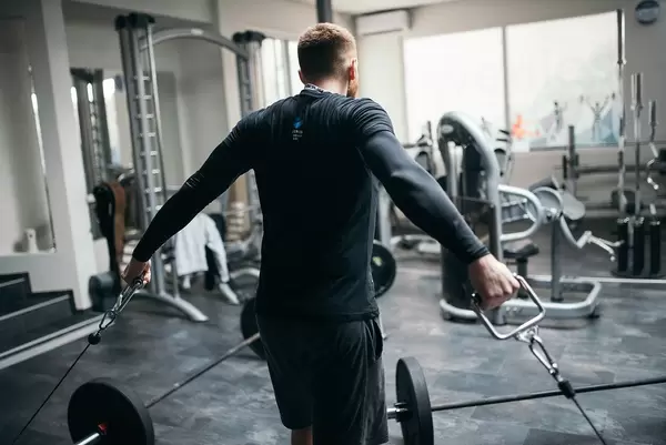 Bokeh Photo of a Man doing chest exercise in an empty Gym