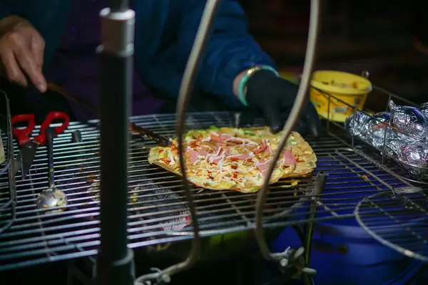Bokeh Photo of Vietnamese Banh Trang Nuong on a Barbecue Grill
