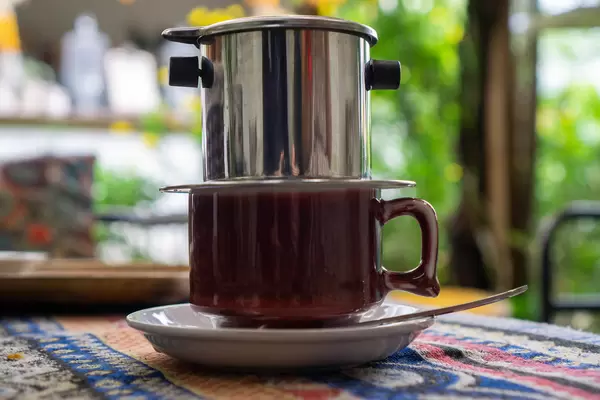 Bokeh Photo of Vietnamese Hot Coffee on a Saucer with Spoon