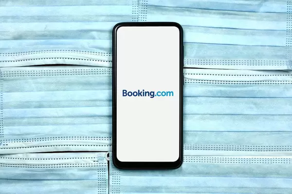 Booking.com - online travel agency for lodging reservation system logo on mobile phone