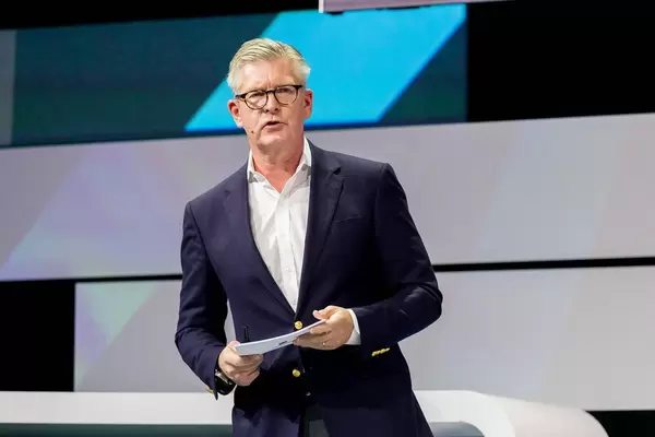 Börje Ekholm with speaker cards on stage of Digital X in Cologne