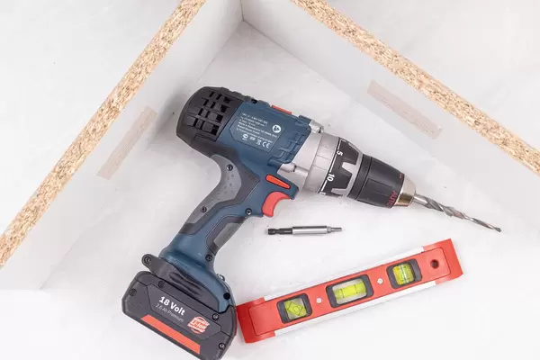 Bosch Acu drill with drill and level in workshop